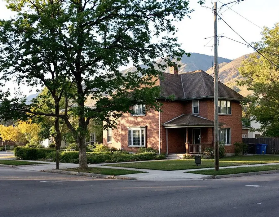 Older two-story brick home on a tree-lined Farmington street