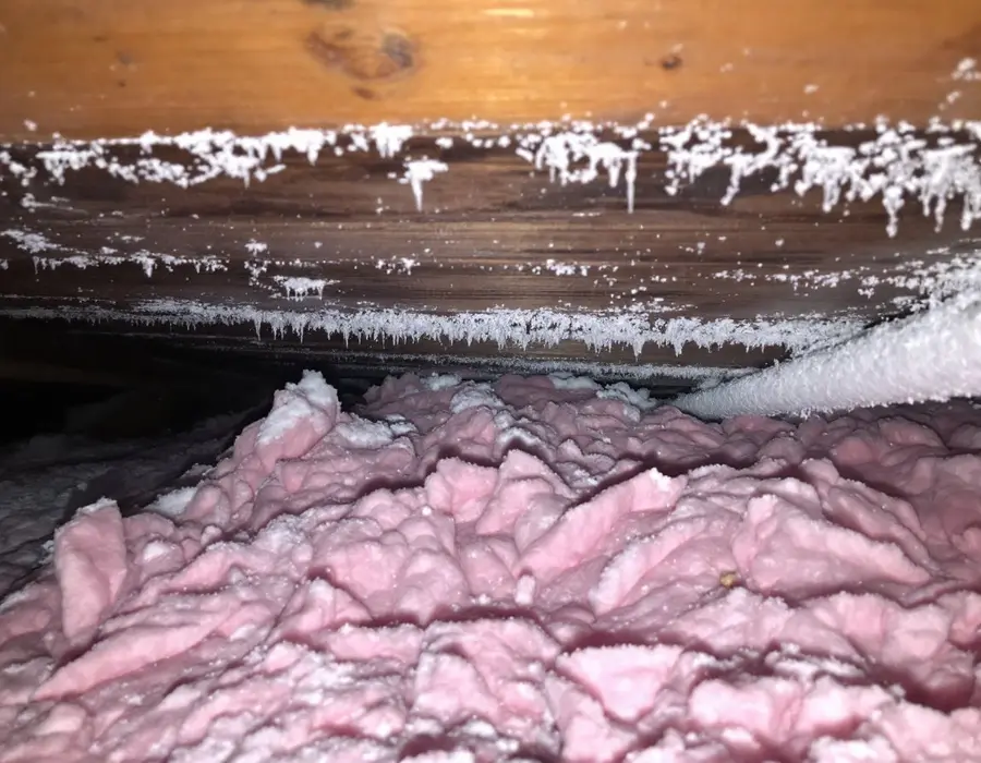 Frost on the underside of the attic decking, a sign of a ventilation problem